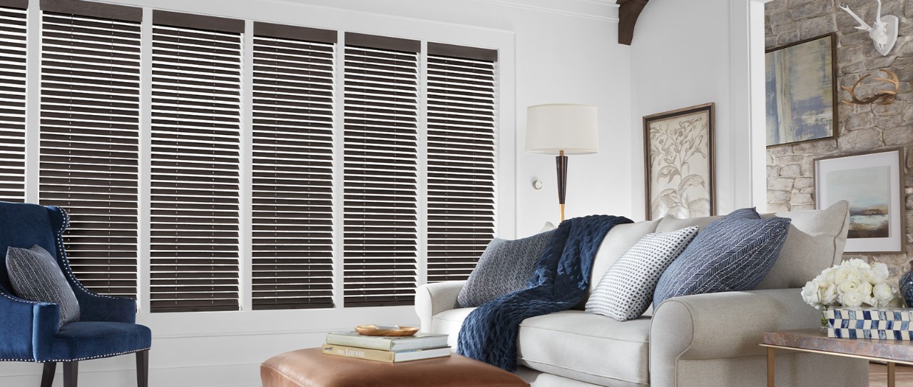 Living room featuring Parkland® Wood Blinds in Basswod  Color: Cosmopolitan